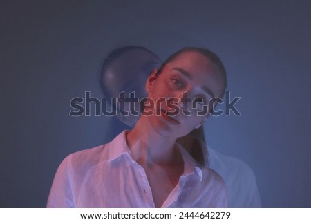 Portrait of beautiful young woman on color background, long-exposure photography