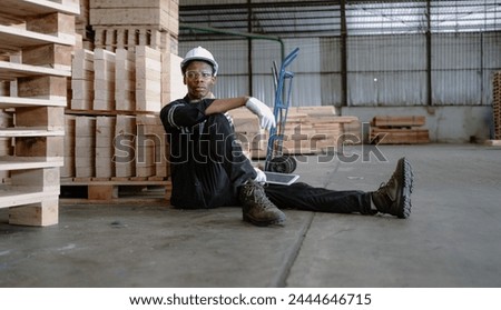 Multiracial engineer, worker sitting resting on floor feel tired from overworked in factory. Young adult technician feel weak, stress, exhausted, worried, frustrated, unhappy, hopeless, or headache Royalty-Free Stock Photo #2444646715