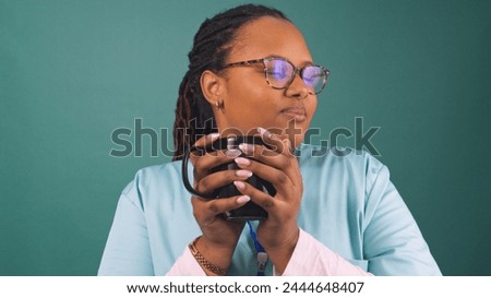 Young Black female nurse drinks coffee and takes a break