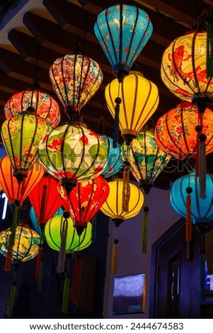 Lanterns and colorful lights on river in Hoi An, Vietnam. Various illuminated paper lanterns hanging at night for celebrating Chinese New Year