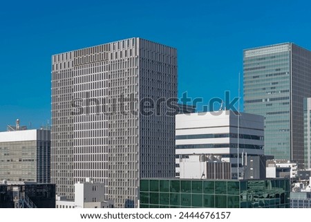 Japanese abstract urban background featuring details of chaotic city buildings and skyline in Tokyo downtown in Ginza district at daytime.   