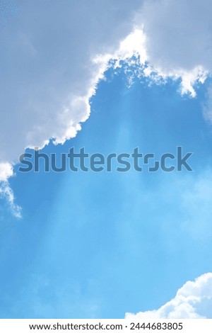 Sunny Blue Sky with Angel Ladder Beams Shining Through the Clouds
