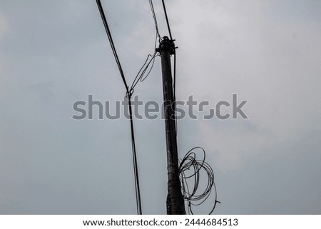 selective focus of utility pole or electricity pole or electric pole or power pole in Indonesia outdoor with blue sky background