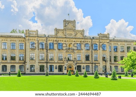 It's photo of main building of the National Technical University of Ukraine. Its view of green lawn in front of Igor Sikorsky Kyiv Polytechnic Institute. It's sunny day with cloudy sky