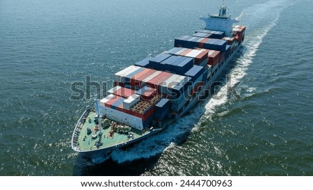 Aerial view of cargo ship with contrail in the ocean sea ship carrying container and running from container international port smart freight shipping by ship service	
