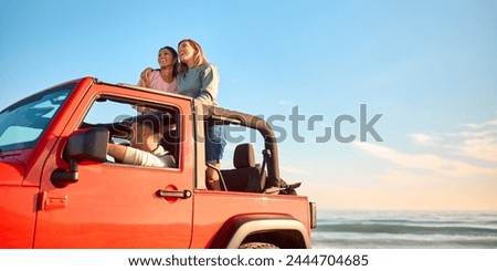 Couple With Friends On Vacation Driving Car On Road Trip Adventure To Beach Standing Up Through Roof Royalty-Free Stock Photo #2444704685