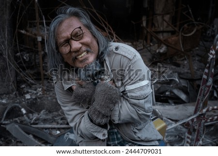 Old man showed signs of madness like a madman when he saw his house destroyed by fire, homeless old man in front of a building destroyed by fire Royalty-Free Stock Photo #2444709031