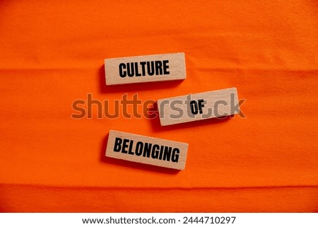 Culture of belonging words written on wooden blocks with orange background. Conceptual business symbol. Copy space.