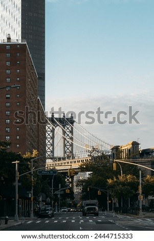 Manhattan Bridge Framed by New York Buildings under Clear Skies