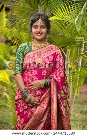 close up of Indian Traditional Beautiful young girl in saree posing outdoors, park