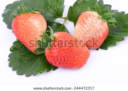 A few fresh strawberries on a white background 