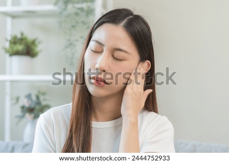 Tinnitus concept, sick asian young woman, girl have ear pain or earache, hand touch plug ear, suffering painful otitis from loud of noisy sound, inflammation. Health care nerve deaf eardrum disease. Royalty-Free Stock Photo #2444752933