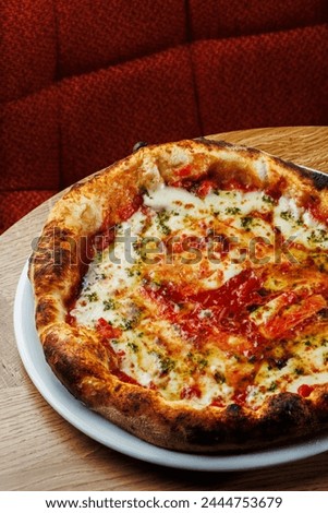 Margherita pizza elegantly presented on a rustic wooden table. Perfect for social media posts and culinary promotions, this photo is available in both vertical and horizontal formats