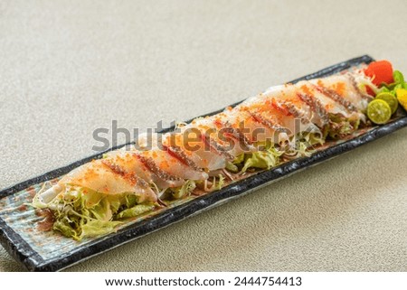 slices sea bream salad，Madai sashimi salad , Japanese food. Royalty-Free Stock Photo #2444754413