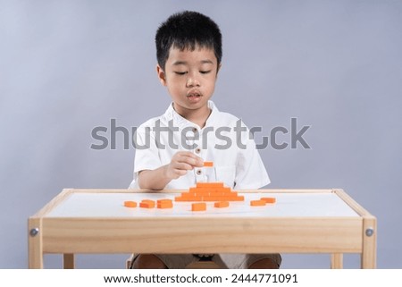 Boy learning to align blocks