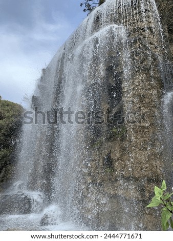Artificial Waterfall at Castle Hill (Colline du Chateau) park. Running water. It is a very popular sightseeing and recreation place. Nice, Cote d'Azur, France Royalty-Free Stock Photo #2444771671