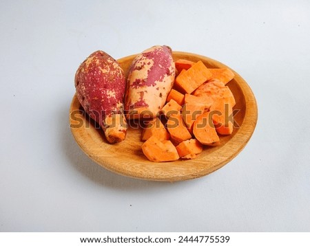 Sliced square sweet potatoes on wooden plate