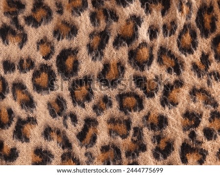 Vintage knitted woolen leopard pattern. Modern knitted animal print.