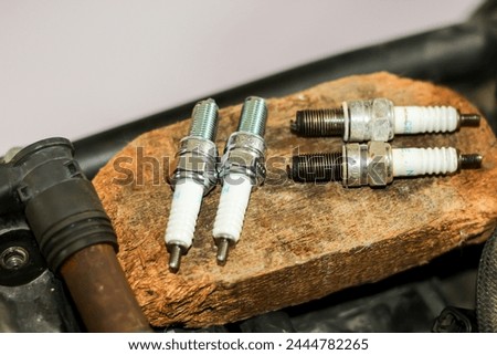 Pictures of spark plug with concept maintenance and repair motorcycles.