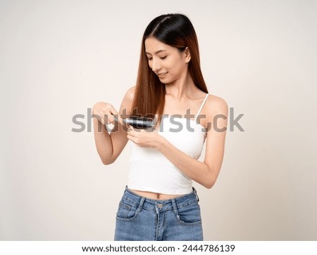 A beautiful woman with long hair is thinking about what style she should cut her hair with scissors or going to a beauty salon.