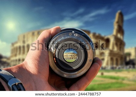 selective focus shot person holding camera lens on Colosseum tourist taking a picture with camera lens on Colosseum