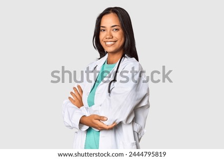Young Filipina doctor confidently posing in studio Royalty-Free Stock Photo #2444795819