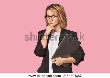 Caucasian middle-aged businesswoman with laptop in studio