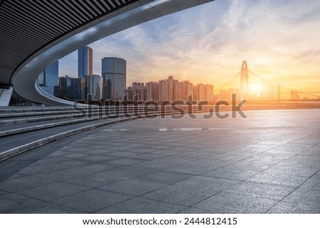 Empty square floor and bridge with modern city buildings at sunrise in Guangzhou