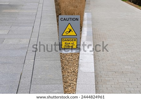 Caution Danger Sign Risk of Falling Between Pathways