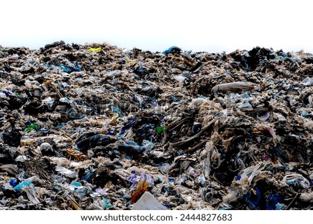 Wall of plastic waste that is difficult to dispose of or decompose naturally Problems of industrial zones Urban communities and 3rd world countries Royalty-Free Stock Photo #2444827683