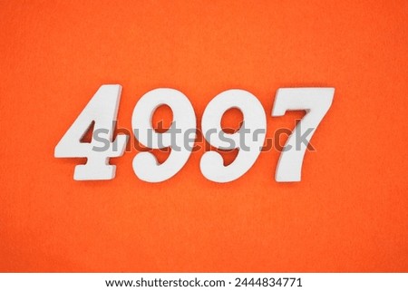 Orange felt is the background. The numbers 4997 are made from white painted wood.