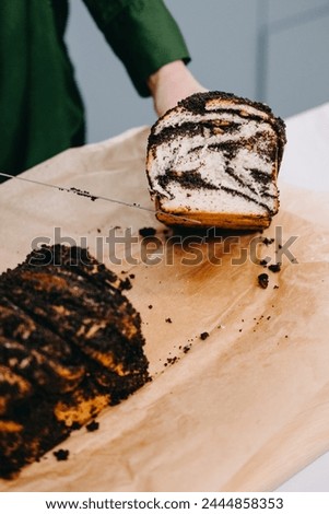 Person Slicing Homemade Poppy Seed Roll