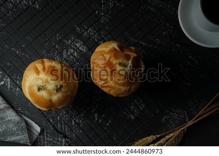 Sweet buns, pineapple filled cupcakes. On a cooling coaster, on a wooden table. Viewed from above
