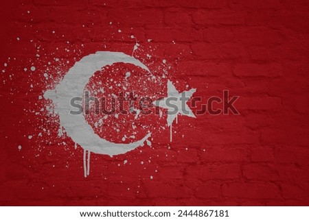 colorful painted big national flag of turkey on a massive old brick wall