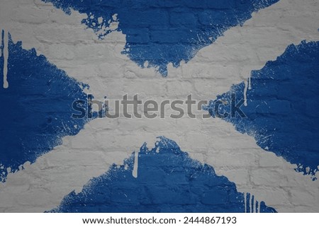 colorful painted big national flag of scotland on a massive old brick wall