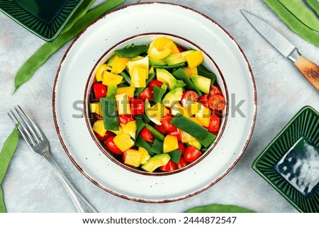 Tasty raw vegetable salad with bell pepper, tomato, avocado and runner beans or green bean. Vegetarian dish. Flat lay. Top view. Royalty-Free Stock Photo #2444872547