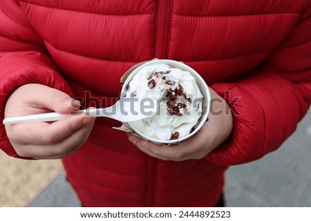 A kid taking an ice cream to welcome spring