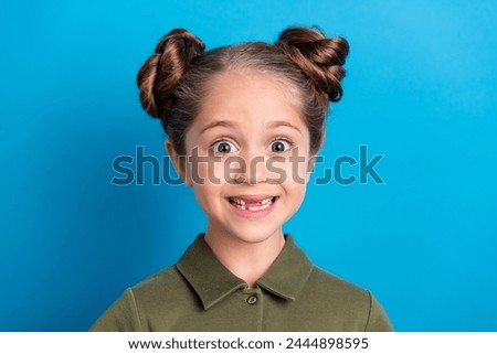 Portrait of positive sweet schoolchild lady impressed preschool unbelievable gift isolated shine blue color background