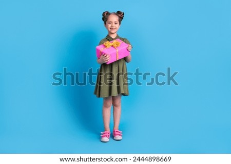 Fill size photo of positive preschool girl hold big package prepare festive occasion event isolated blue color background