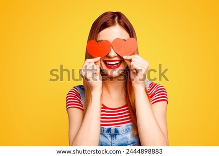 I love you Close up studio photo portrait of cute lovely pretty with beaming toothy smile girl covering eyes with small little postcards in shape on heart isolated bright vivid background