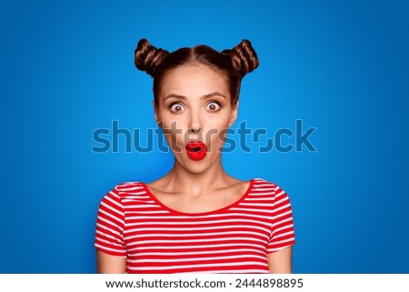  Closeup portrait of shocked impressed model with red lips with unexpected unbelievable reaction looking at camera with wide open eyes and mouth isolated on red background
