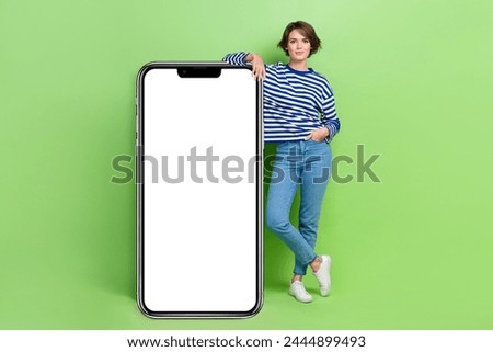 Full body size photo of young bob brown hair woman wear trendy casual outfit near smartphone interface menu ad isolated on green background