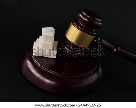 Harm of Sweet Sugar and Judgment with a gavel. Court decision and judge verdict on sweet and sugar concept Royalty-Free Stock Photo #2444916925