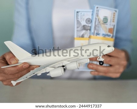 Airplane and money. Plane on the background of USA dollars. The cost of travel, air tickets and flights, financial expenses for vacation
