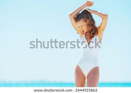 happy young woman having fun time on beach