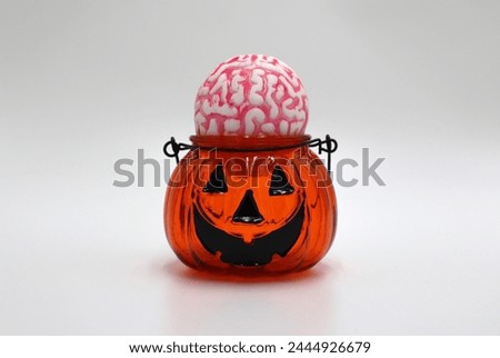 Halloween Pumpkin face smile feeding on human brain background