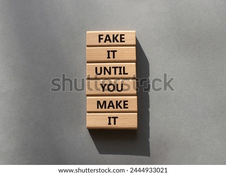Fake it until you make it symbol. Concept words Fake it until you make it on wooden blocks. Beautiful grey background. Business concept. Copy space.