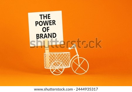 The power of brand symbol. Concept words The power of brand on beautiful white paper on clothespin. Bicycle model. Beautiful orange background. Business the power of brand concept. Copy space.