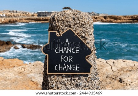 A chance for change symbol. Concept words A chance for change on beautiful black chalk blackboard. Beautiful stone blue sea sky background. Business A chance for change concept. Copy space.