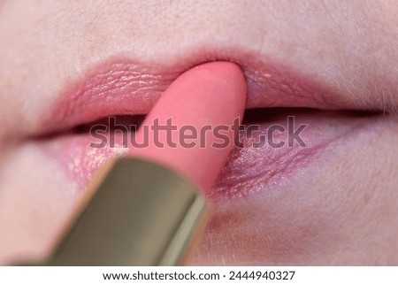Close-up of pink iridescent lipstick coloring female lips, enhancing beauty and style, showcasing lip care and cosmetic concepts, Makeup and Beauty Products